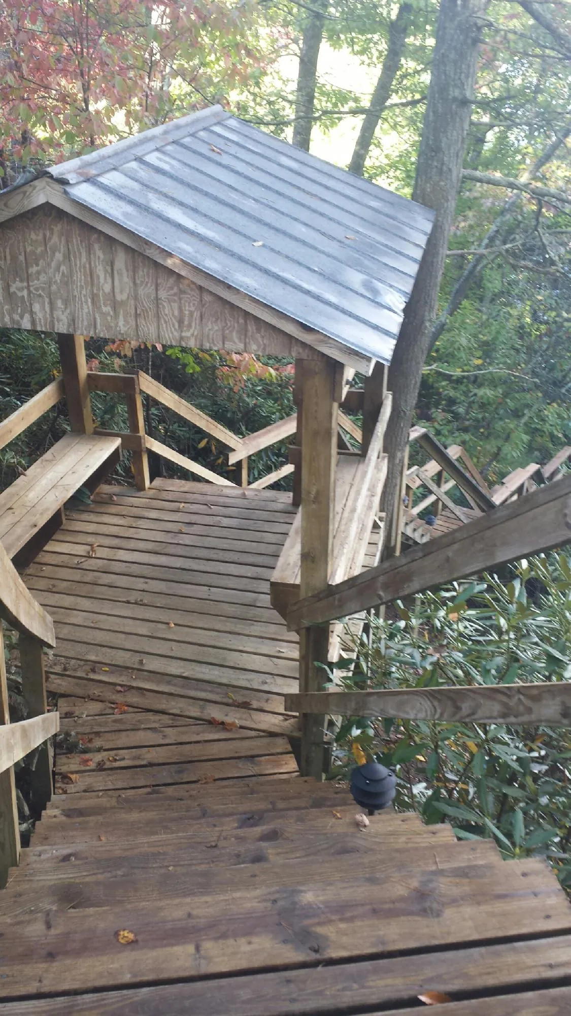 Metal roofed shelter over wooden steps on a wooded walkway — Skylight Repair & Installation work by our crew in Haddonfield